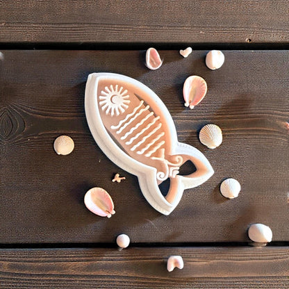 sun fish cutter and imprint on wood with small shells