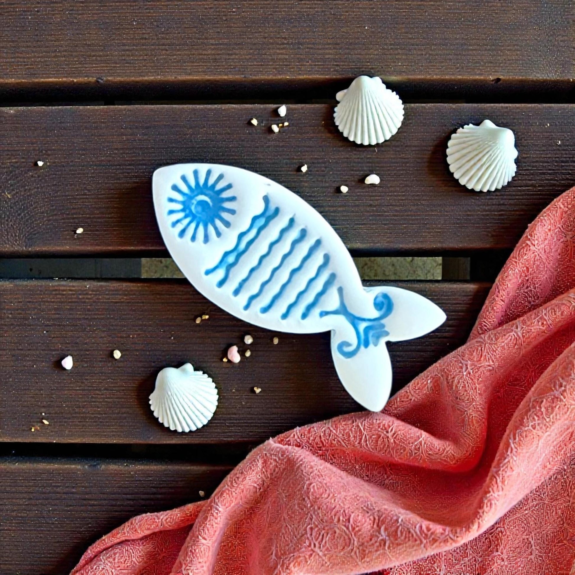 blue sun fish clay imprint with shells and coral fabric