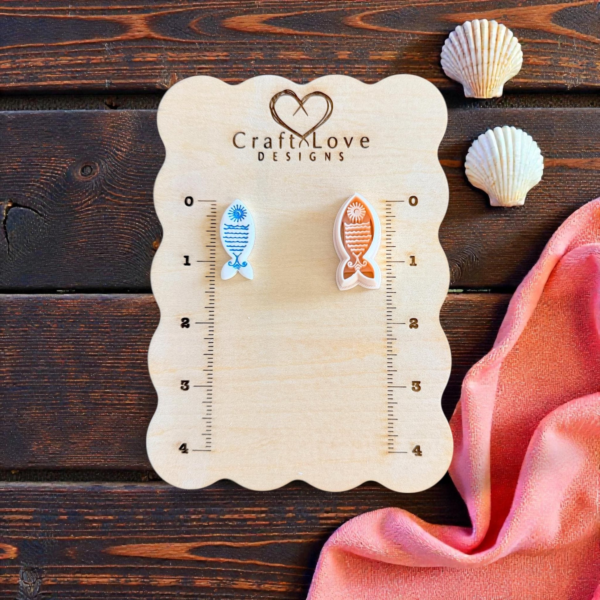 two sun fish imprints on wooden measuring board