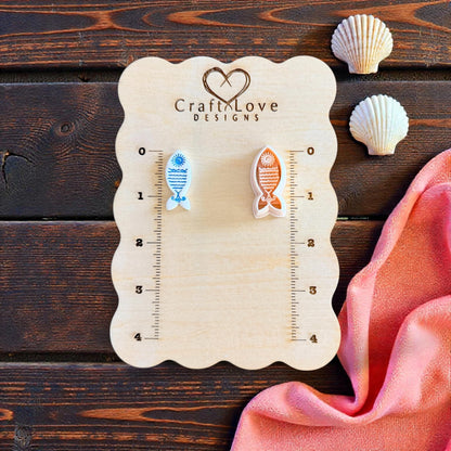 two sun fish imprints on wooden measuring board