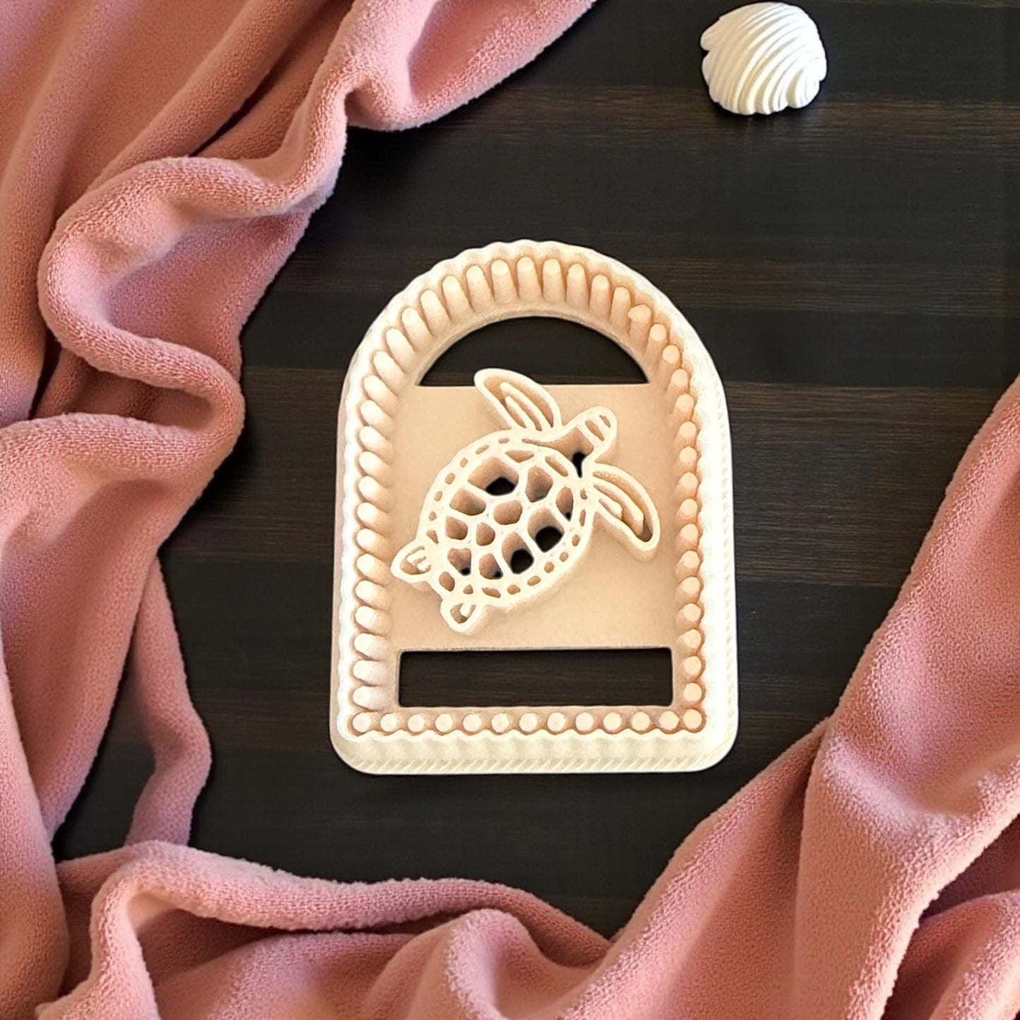 turtle cutter on wooden measuring board with shells