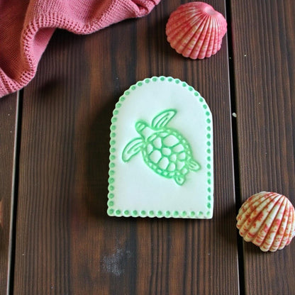 green sea turtle clay imprint in arched shape with dotted border