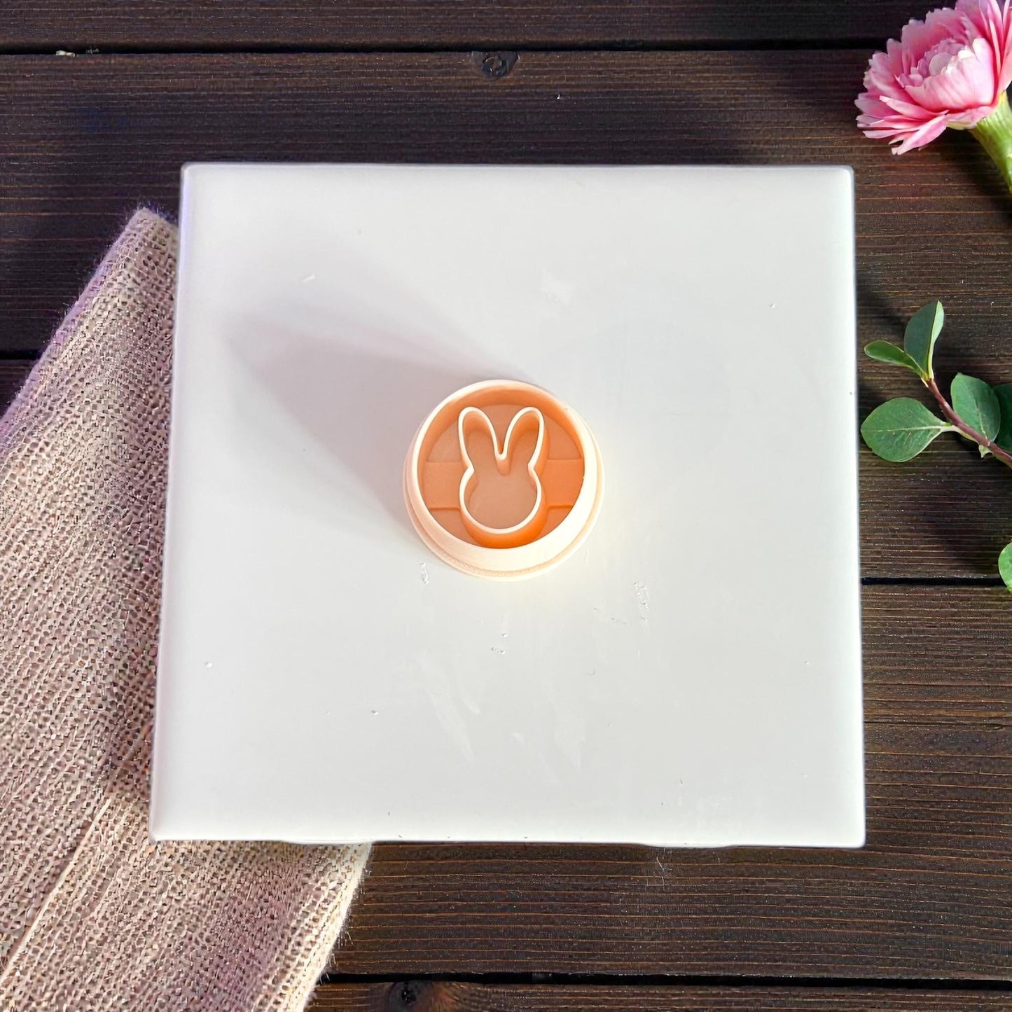 peach bunny cutter on white tile