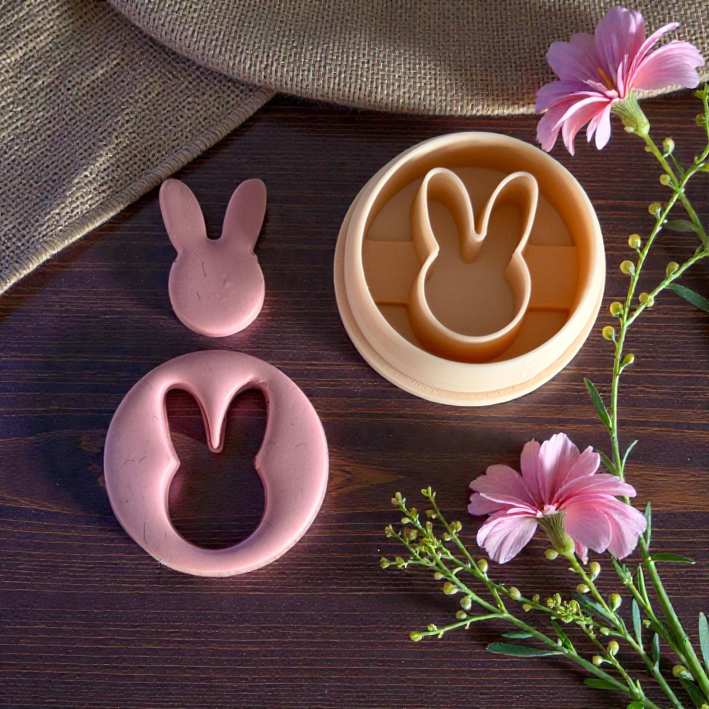 bunny clay cutouts beside peach cutter with flowers