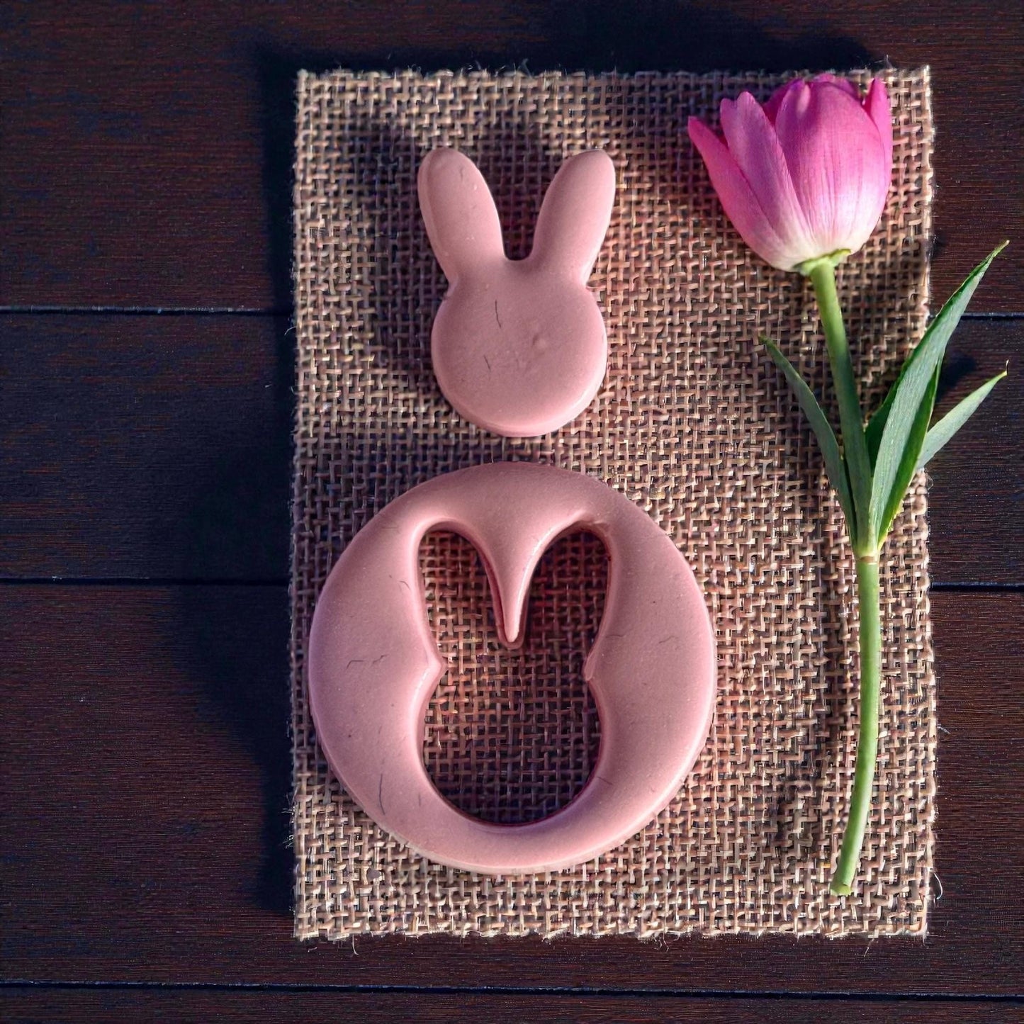 bunny clay cutouts on burlap with pink flower