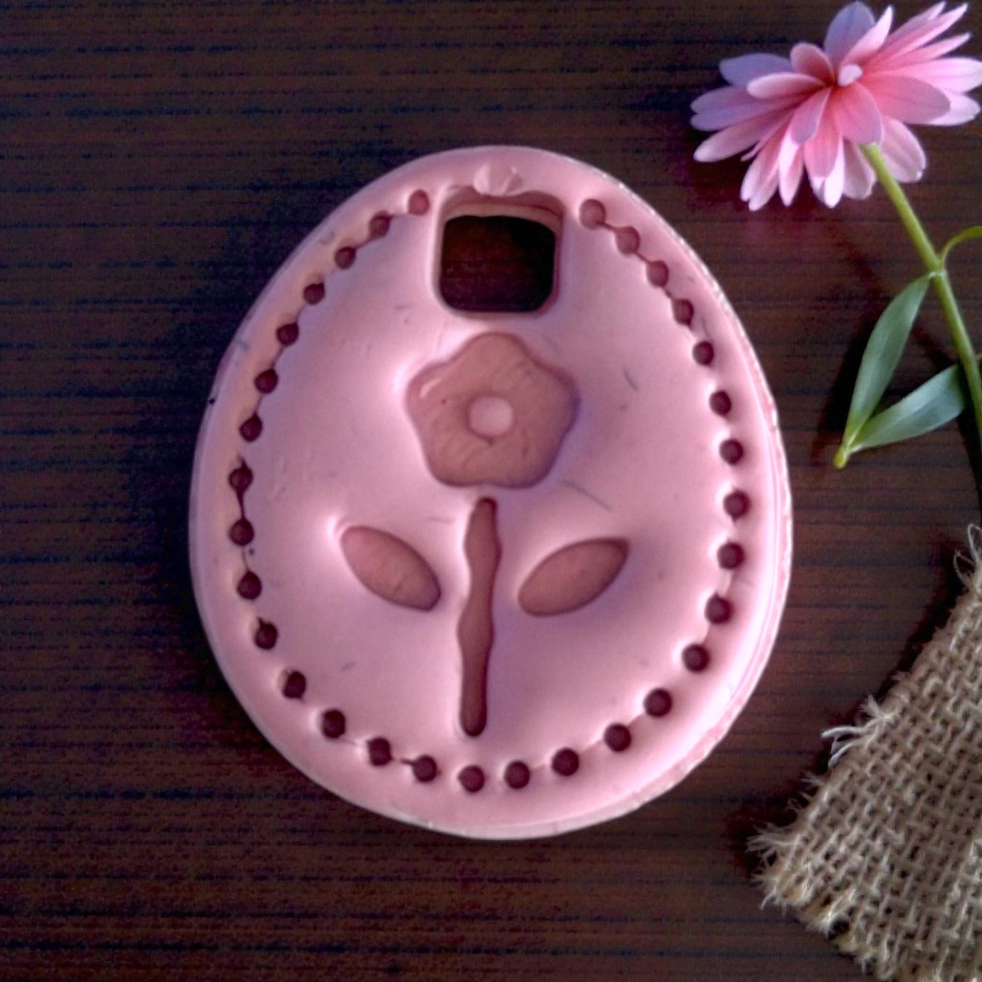 pink floral oval charm closeup with flower decor