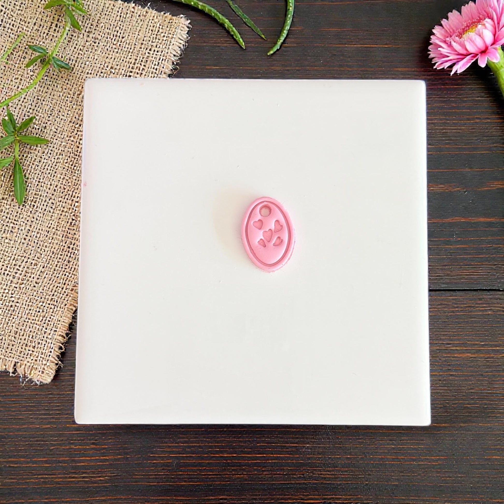 small pink oval heart charm clay impression