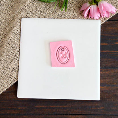 pink oval heart charm cutter on white tile