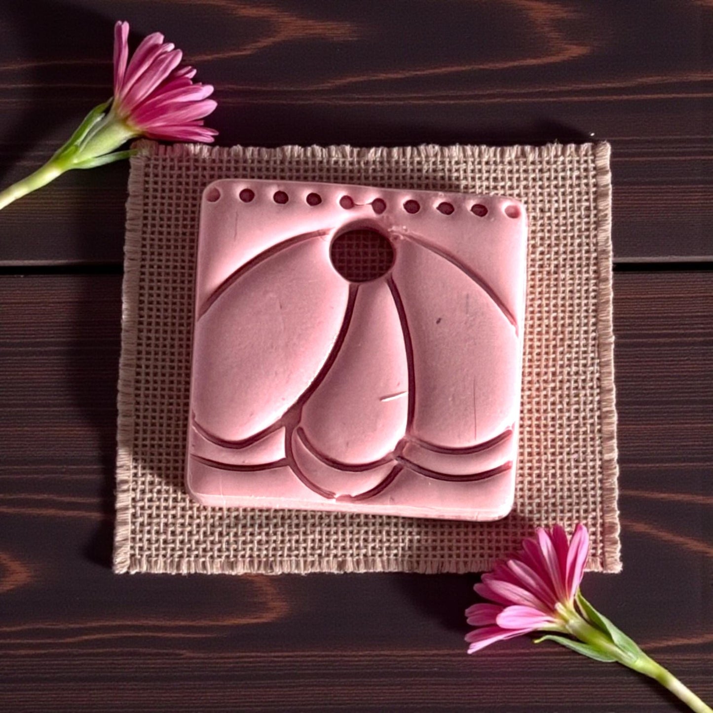close up clay charm with scalloped petal details