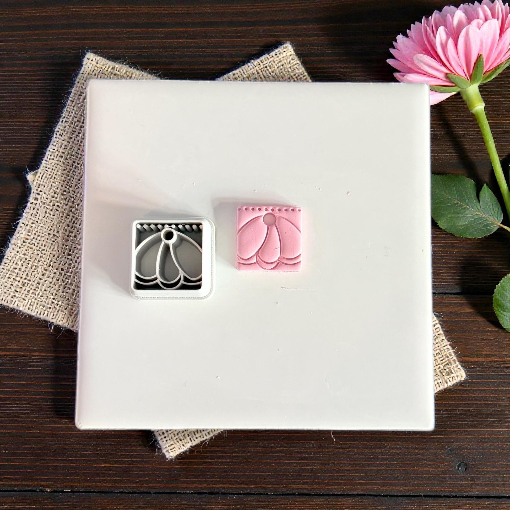 clay cutter and stamped clay charm side by side