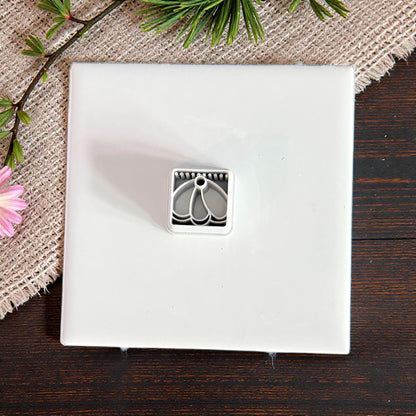 small cutter displayed on white tile