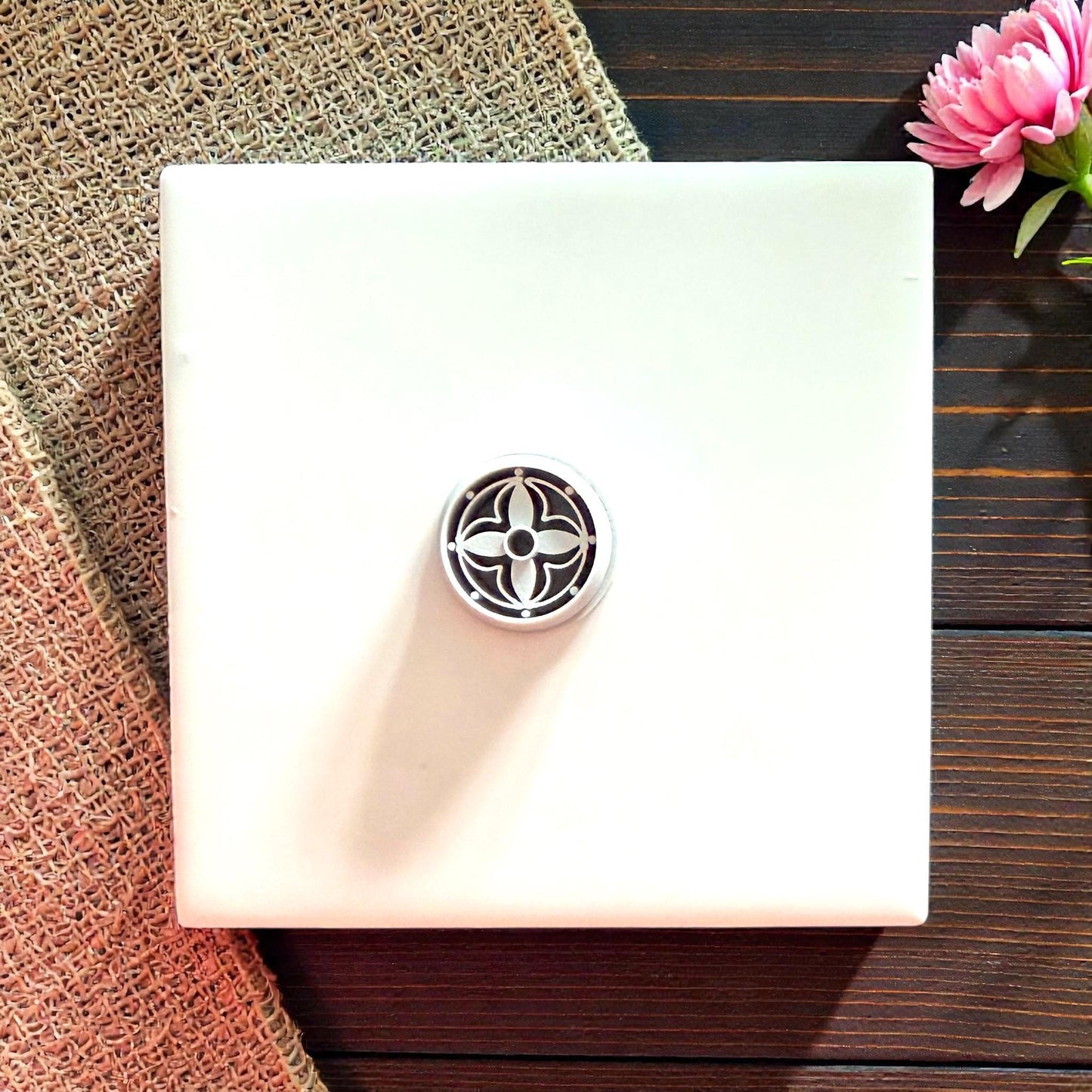 small round floral polymer clay cutter on white tile