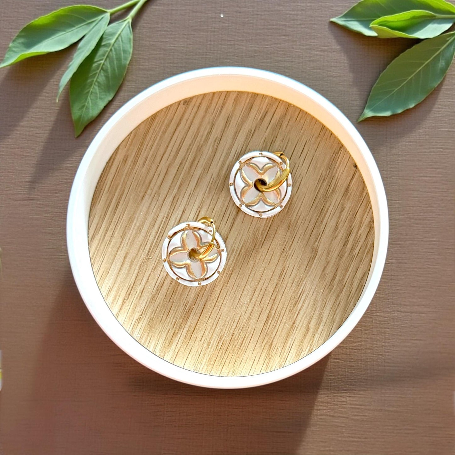 round floral clay charms on wood tray
