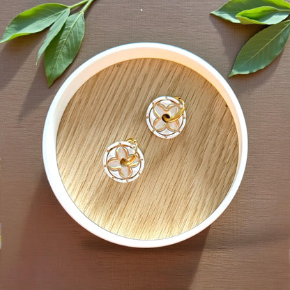 round floral clay charms on wood tray