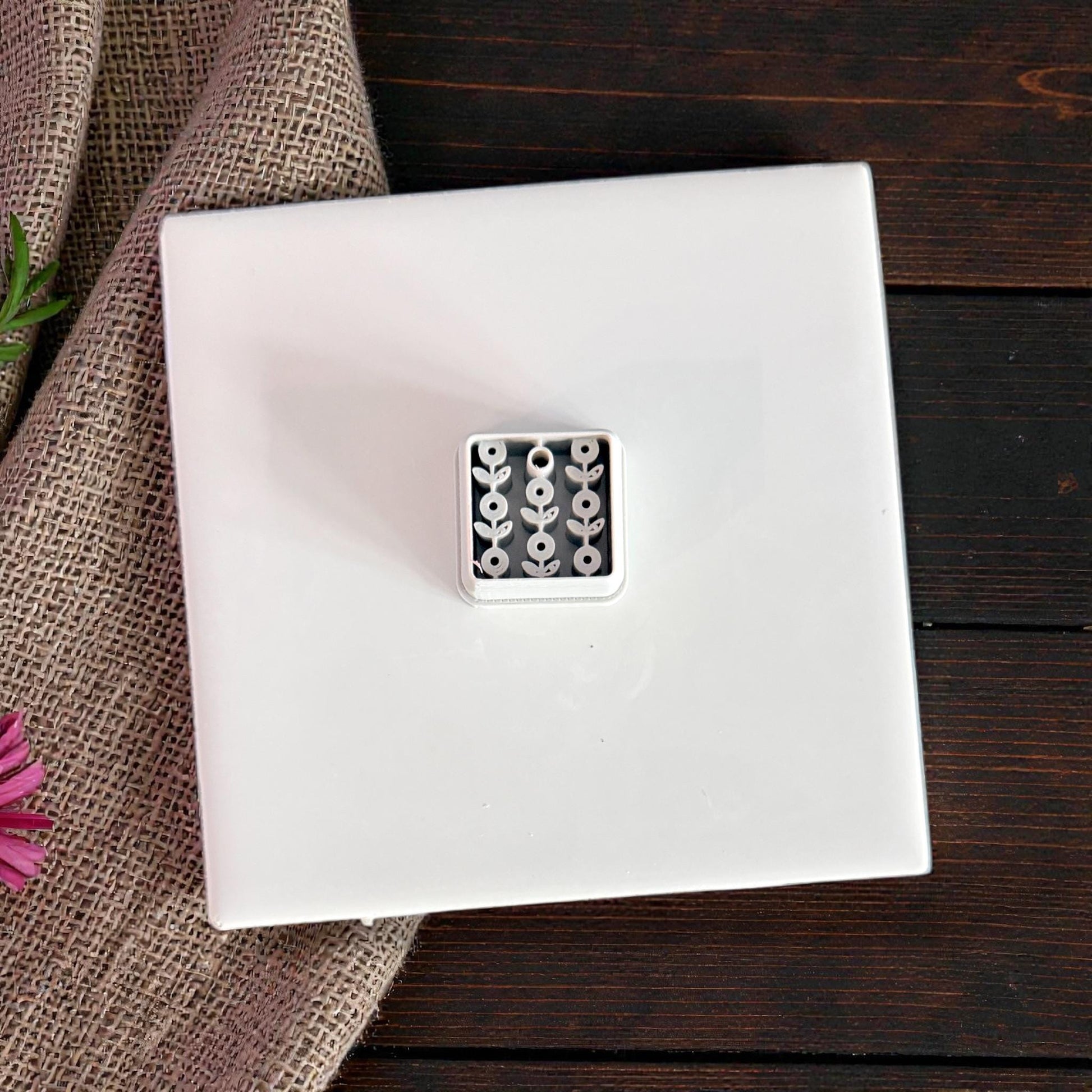 white floral clay cutter on white tile