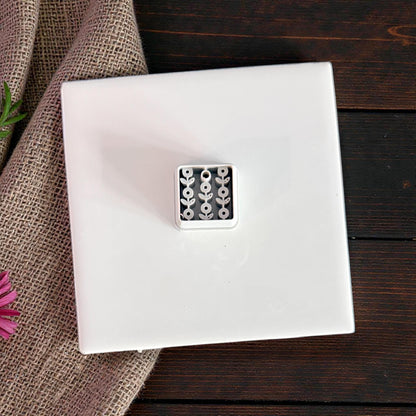white floral clay cutter on white tile