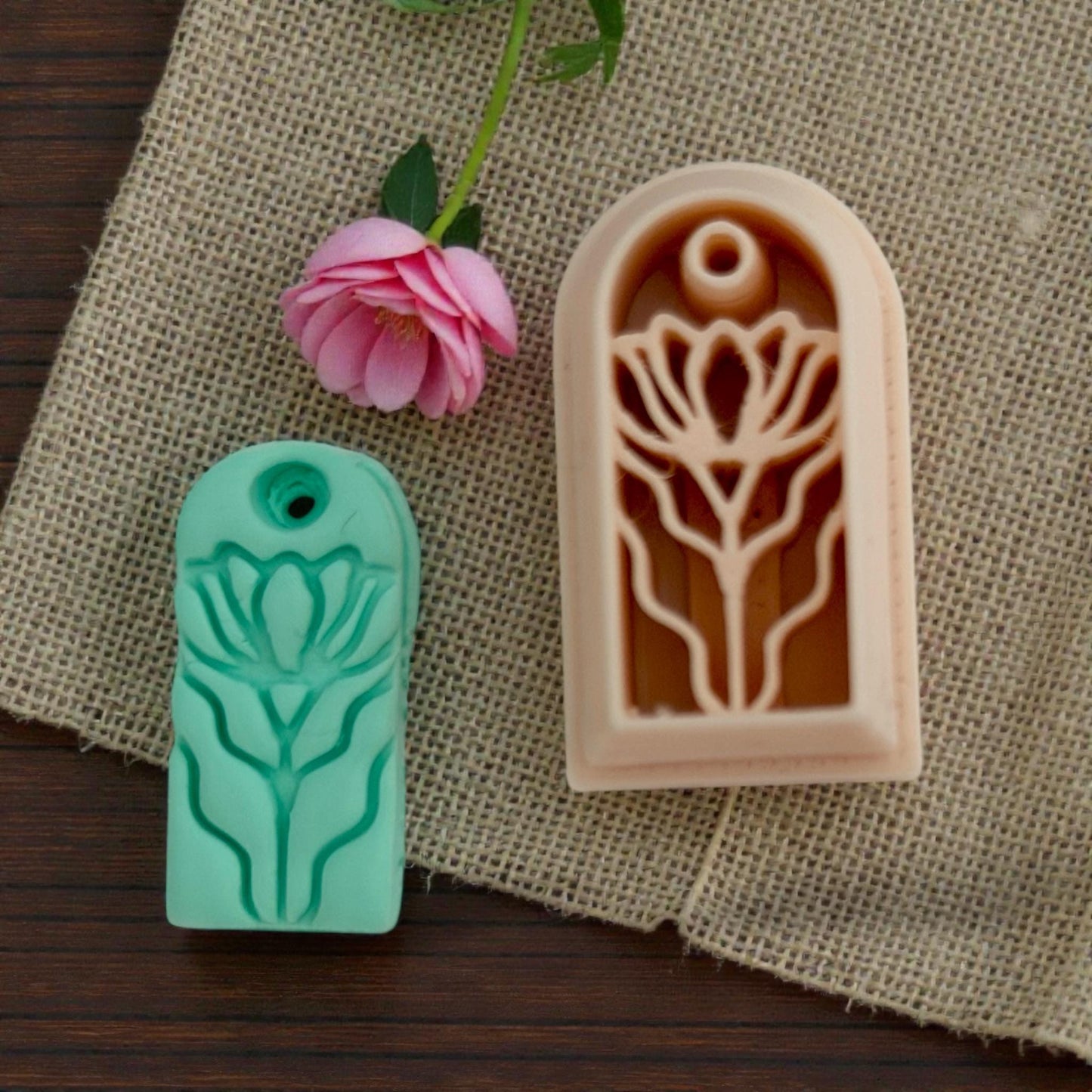 Green floral clay charm  and cutter on burlap