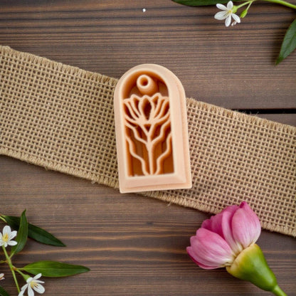 Arched floral polymer clay cutter on burlap