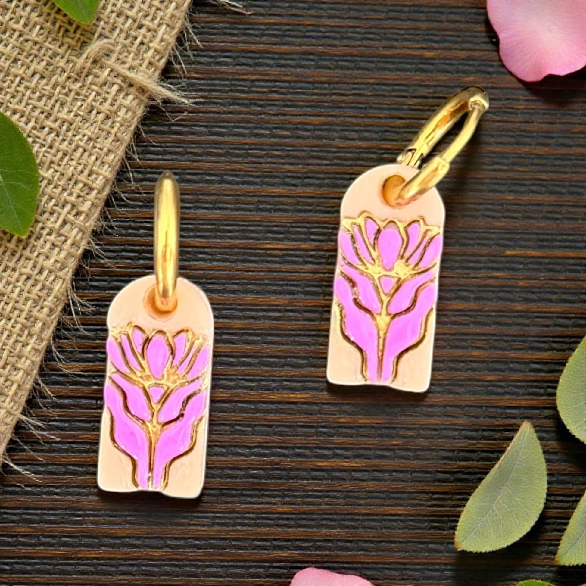 Pink floral charm earrings styled with flowers