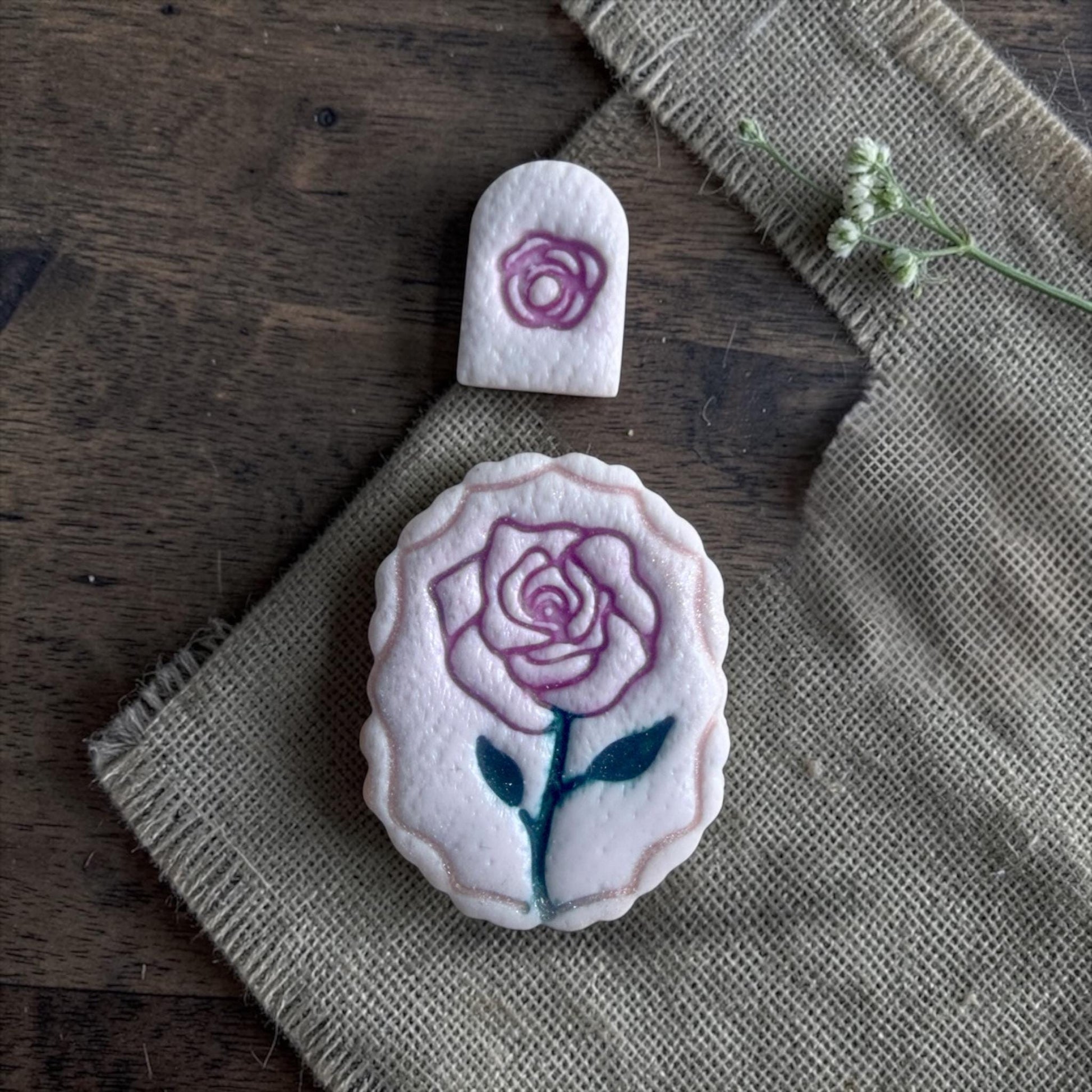 rose clay imprints on burlap fabric with small rose topper imprint