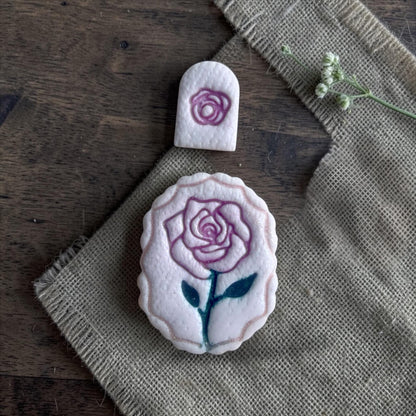 rose clay imprints on burlap fabric with small rose topper imprint