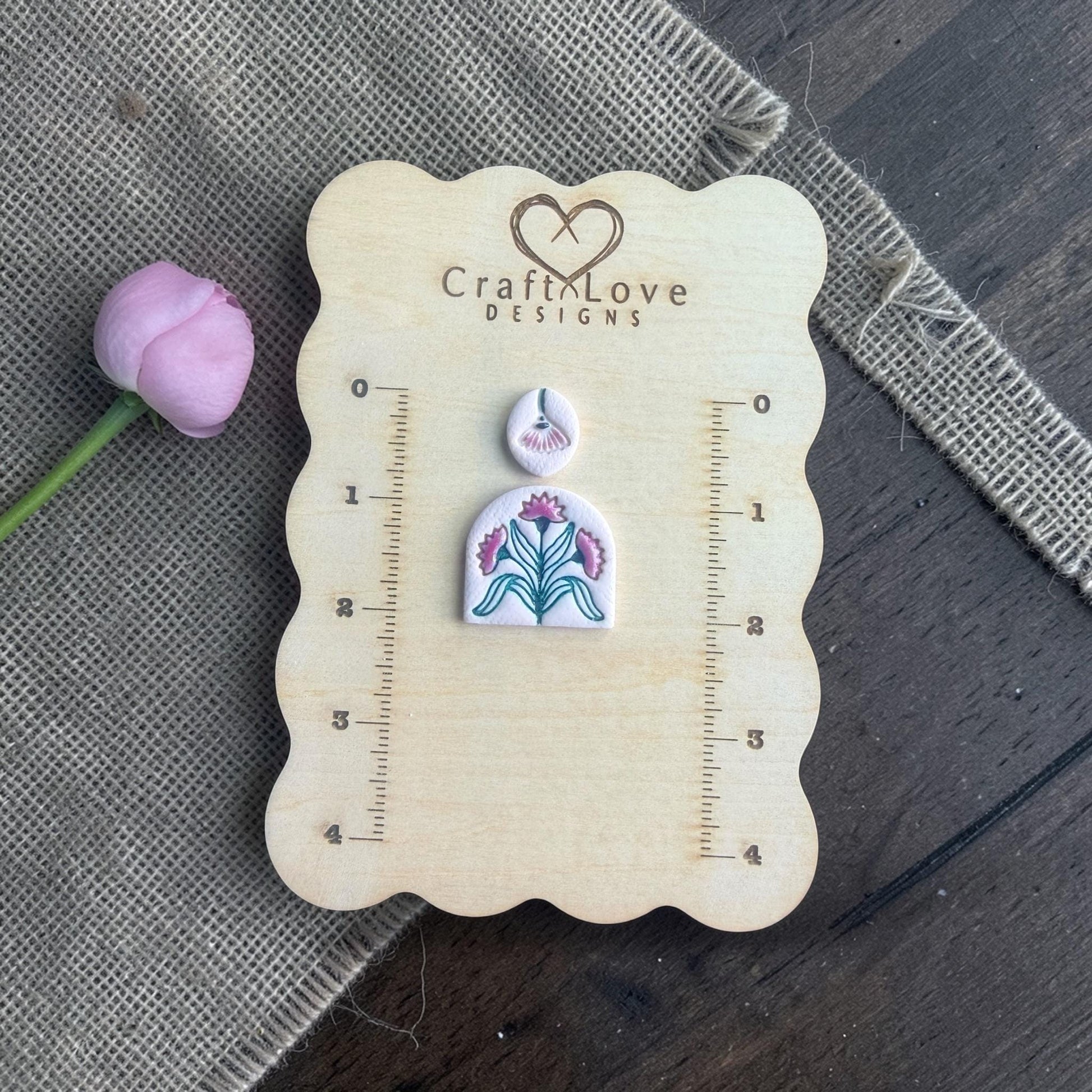floral arch and topper clay imprints on wooden sizing board