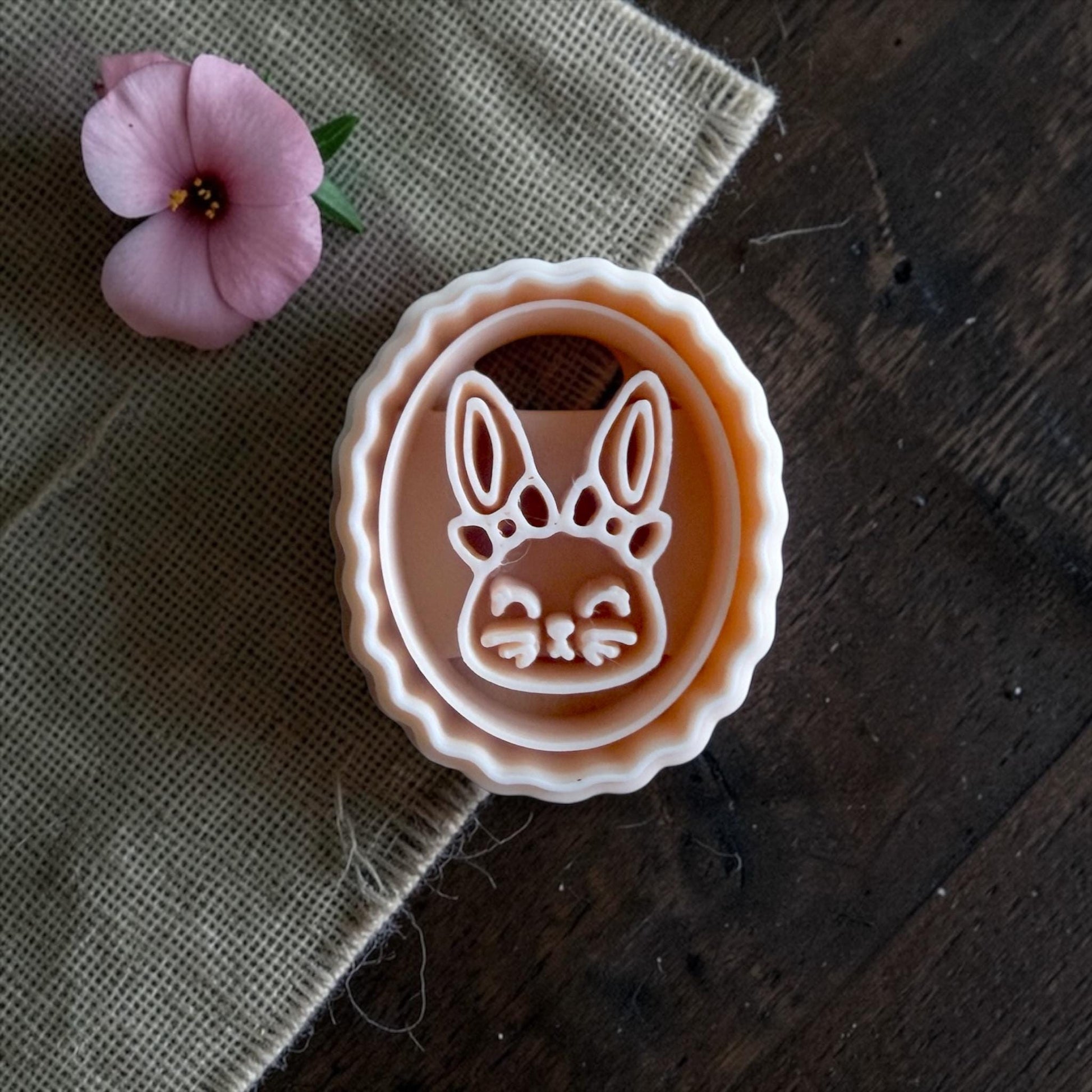 bunny clay imprint and cutter displayed side by side on sizing board