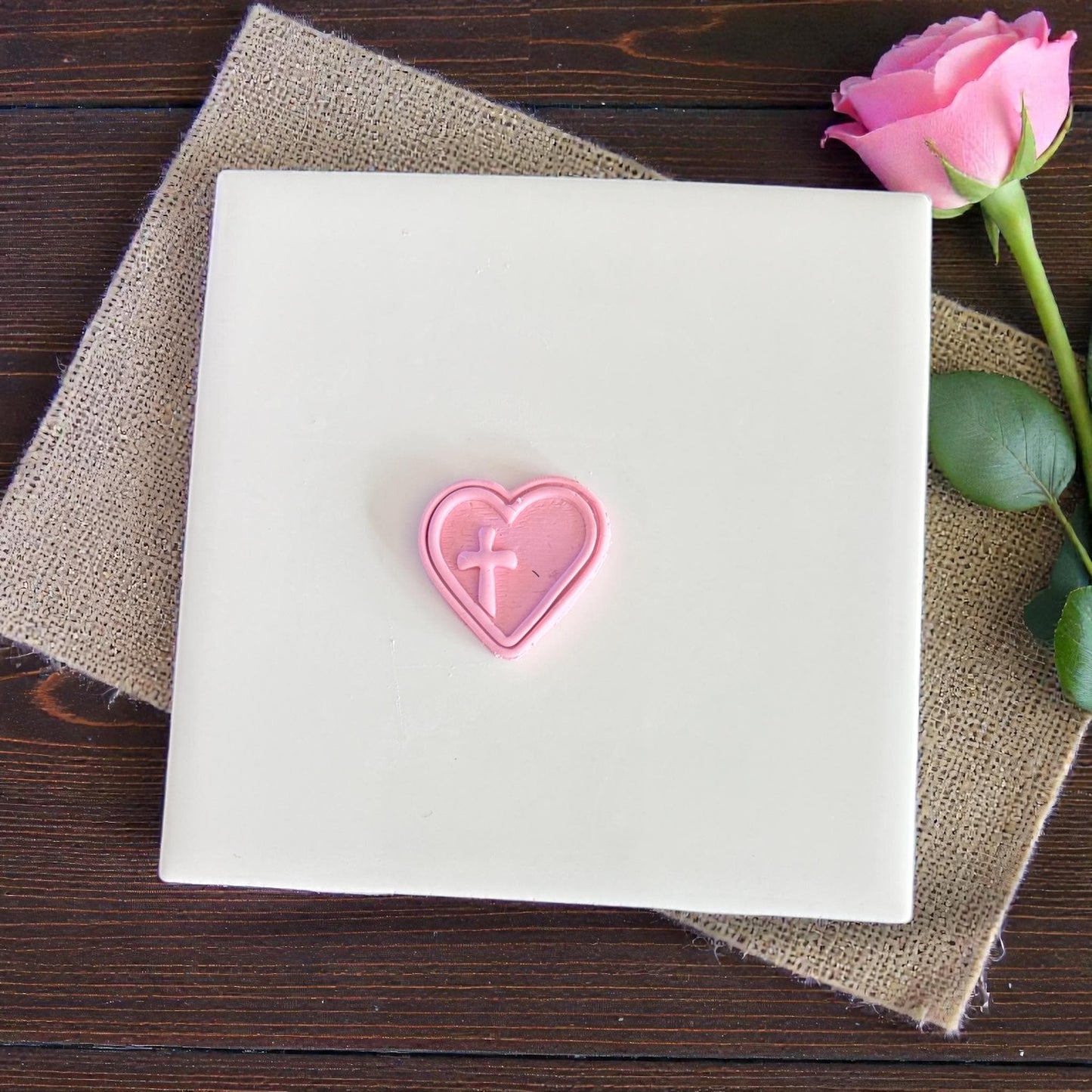 heart cross polymer clay imprint displayed on white tile