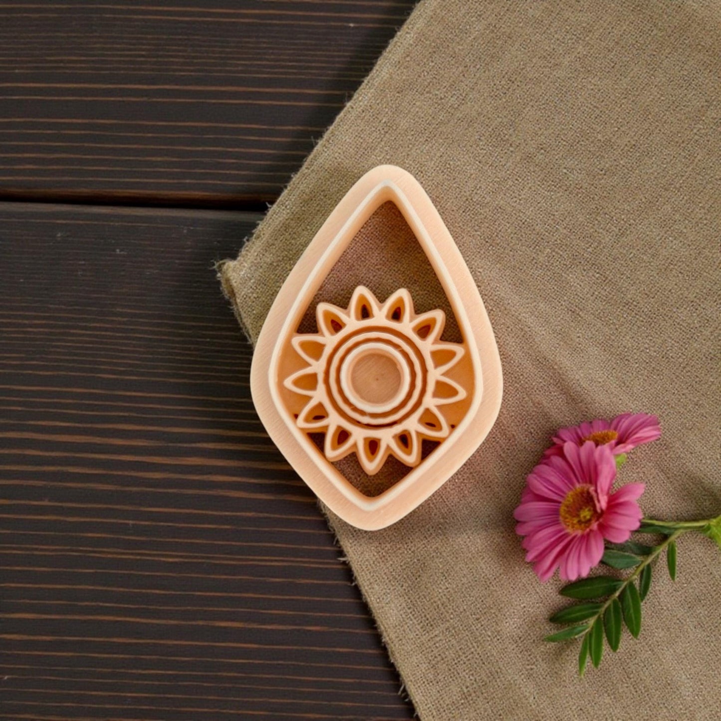 sunburst teardrop clay cutter closeup with pink flowe