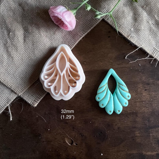 32mm boho botanical clay cutter photographed with teal clay earring