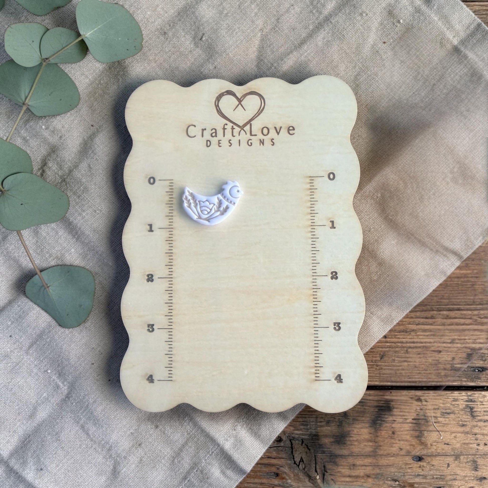 blue clay stamped bird example on measuring board