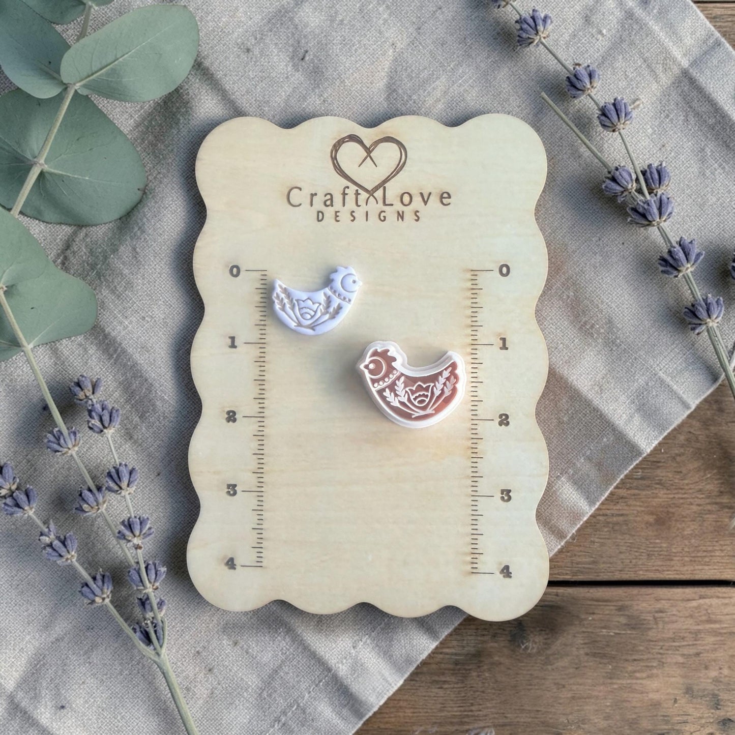 folk bird clay cutter on measuring board close view