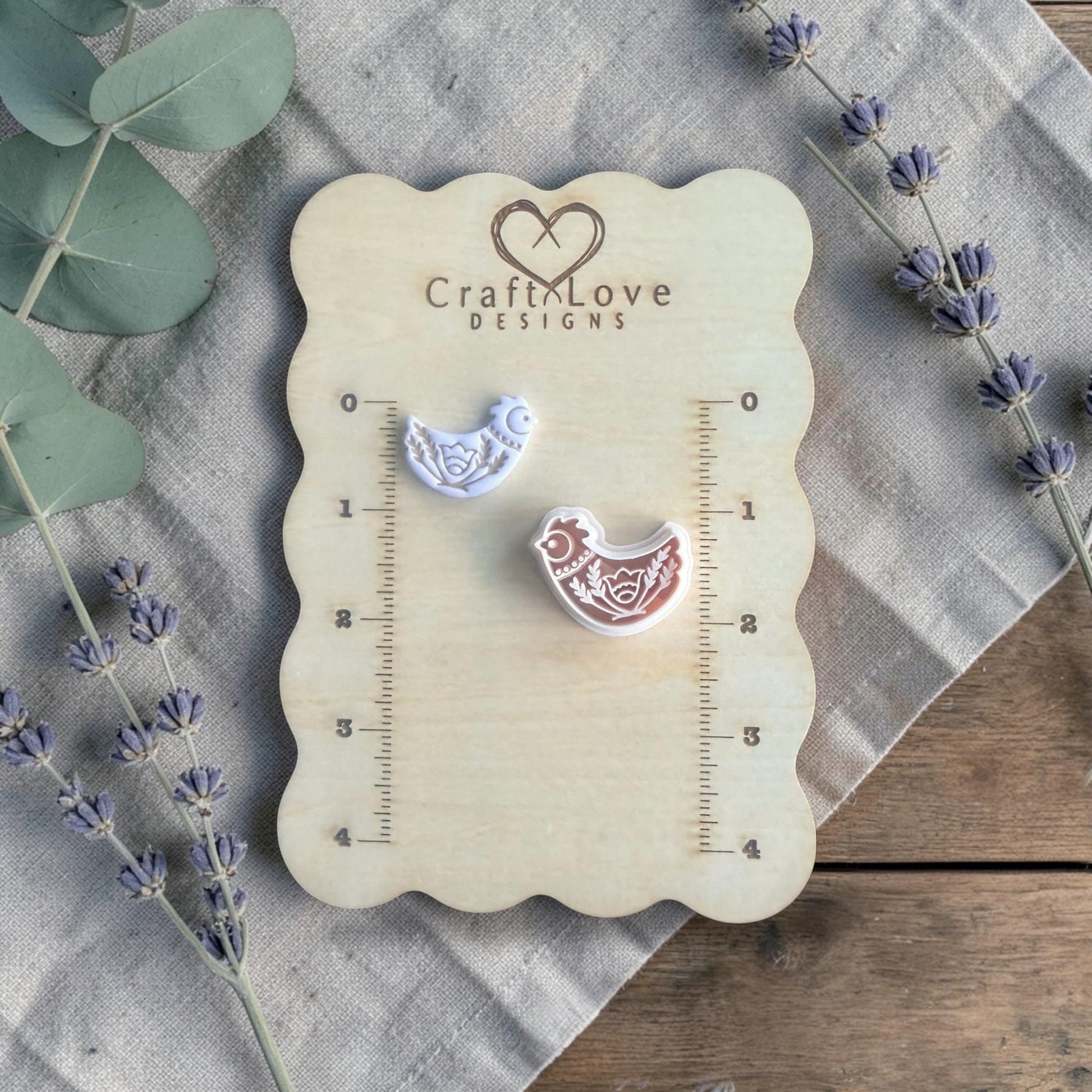 folk bird clay cutter on measuring board close view