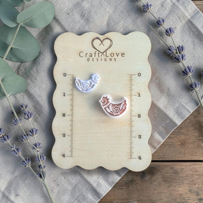 folk bird clay cutter on measuring board close view