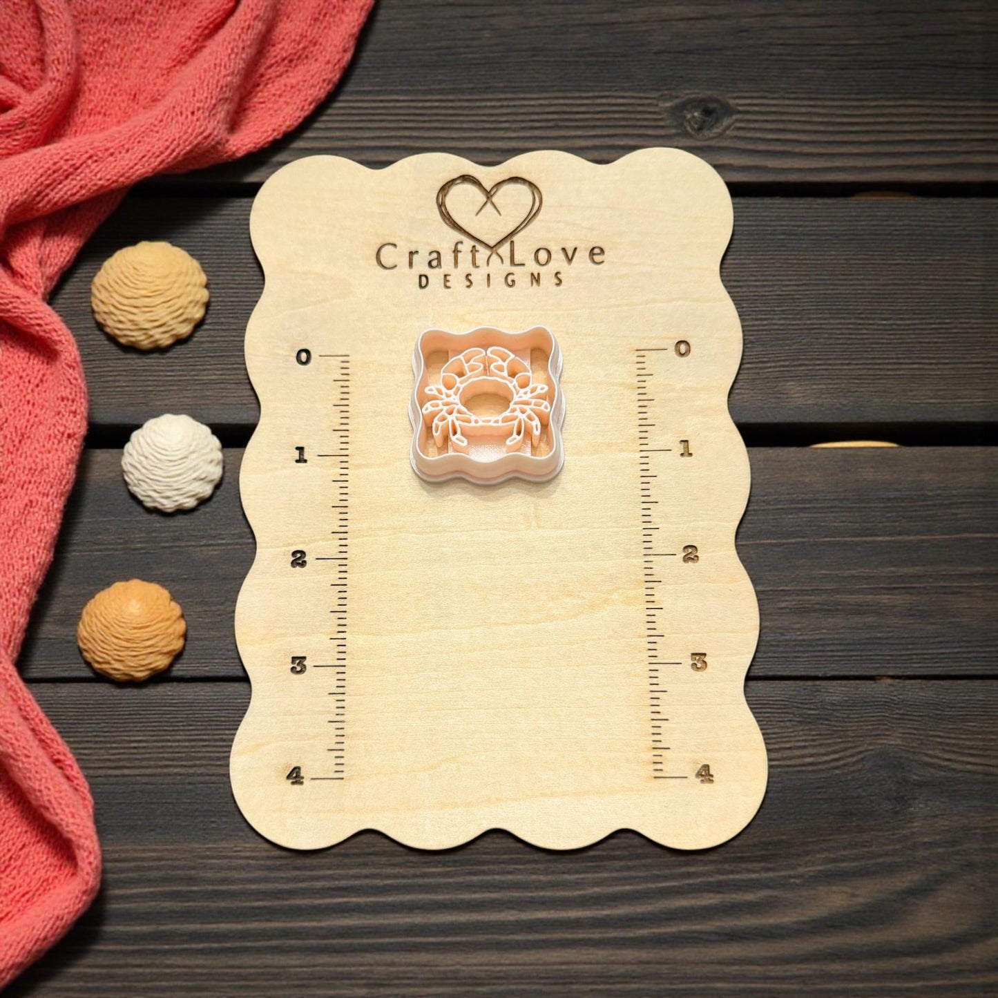 scalloped crab cutter on wooden board with seashell accents