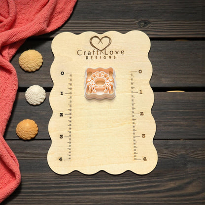 scalloped crab cutter on wooden board with seashell accents