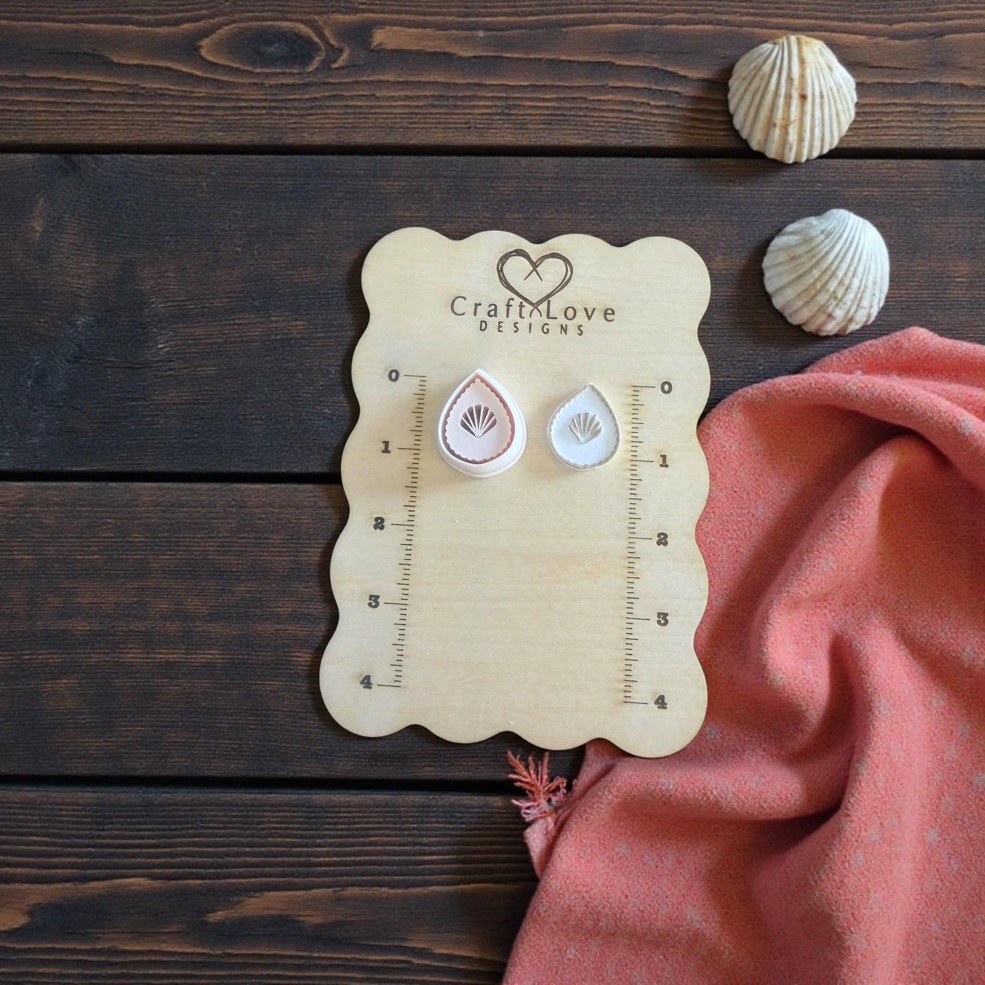 teardrop seashell cutter and imprint with pink fabric and shells