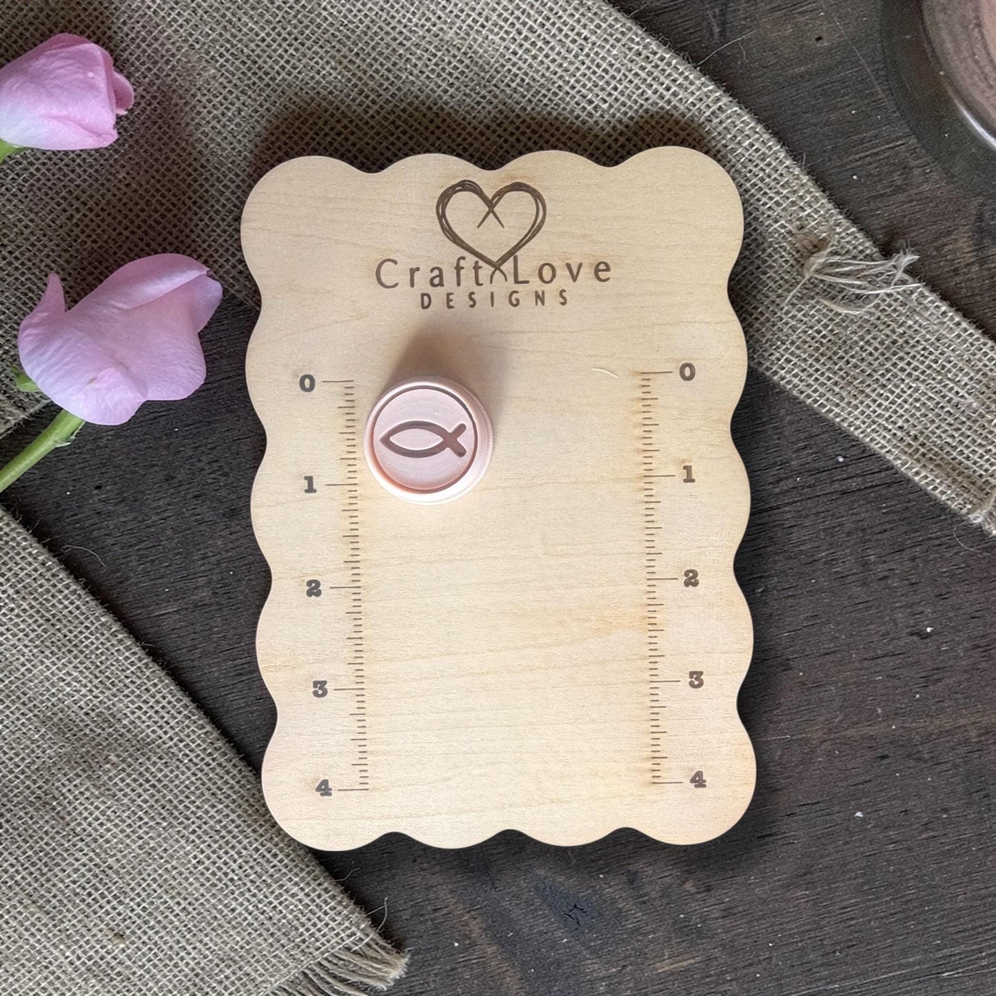 Polymer clay cutter with Ichthys fish placed on Craft Love Designs ruler board for size reference