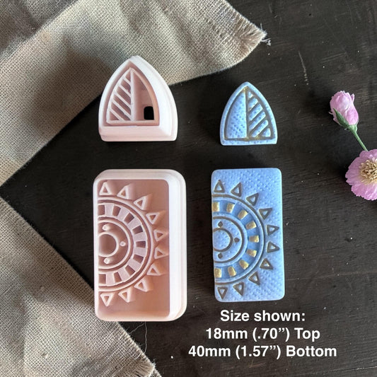 Polymer clay cutters and finished blue clay earrings with triangular stud and sunburst rectangle dangle