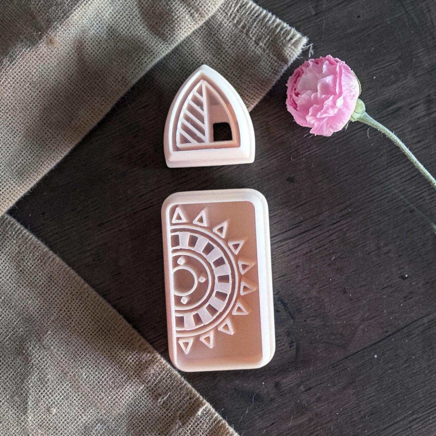 Polymer clay cutters displayed on burlap fabric table