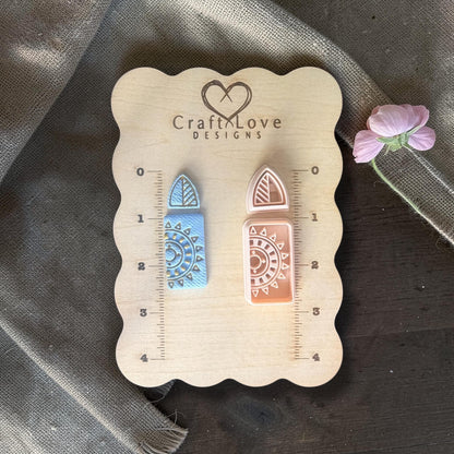 Polymer clay cutters and finished blue clay earrings with triangular stud and sunburst rectangle dangle