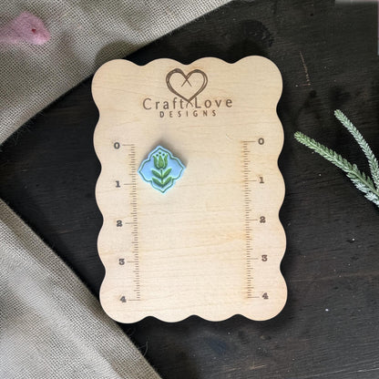Finished blue clay tulip charm on Craft Love Designs ruler board