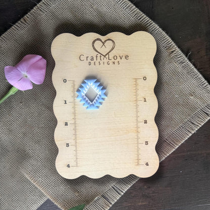Finished blue aztec clay charm on Craft Love Designs ruler board