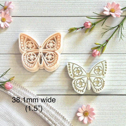 floral wings imprint next to cutter