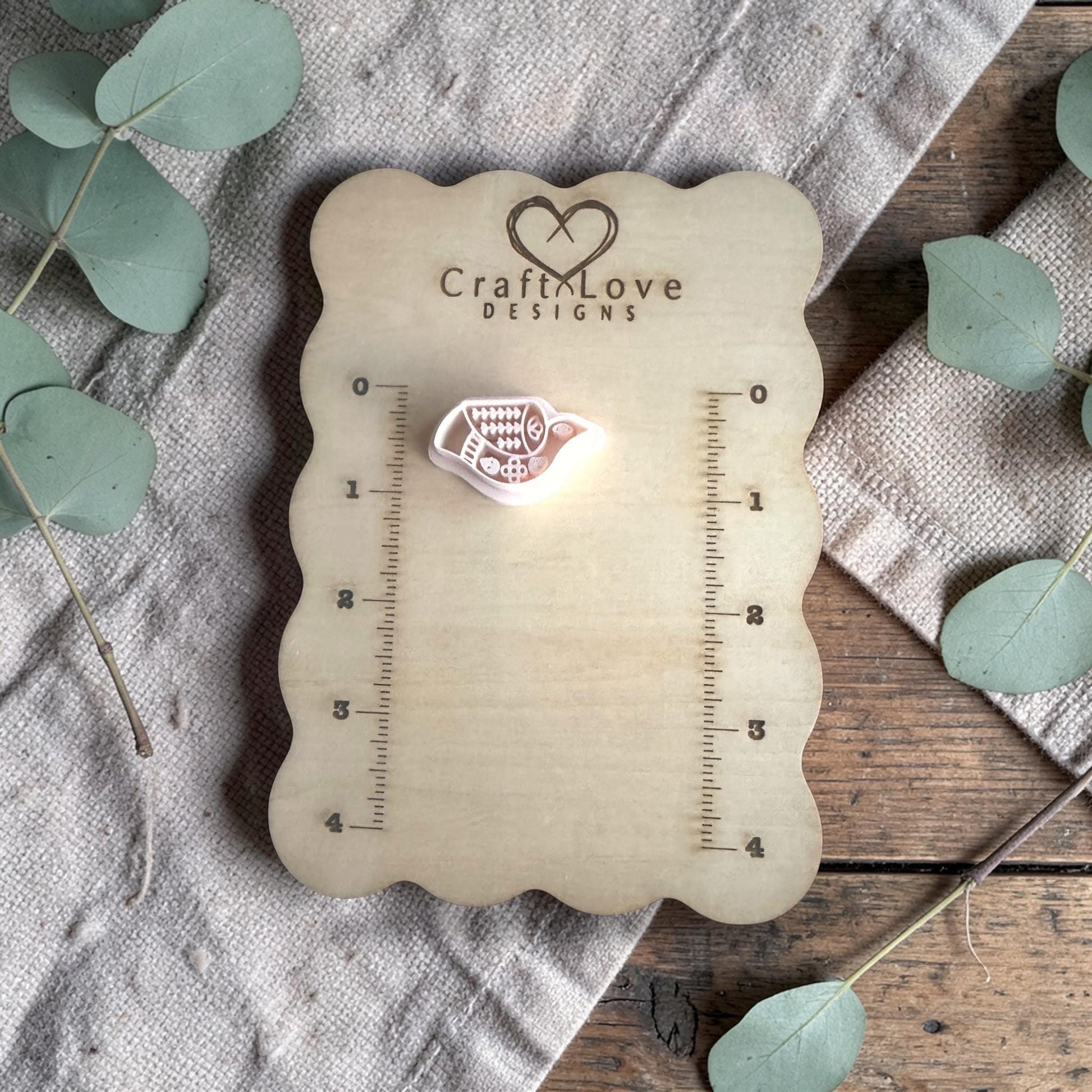 white polymer clay bird cutter displayed on Craft Love Designs ruler board