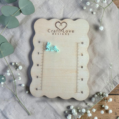 finished turquoise rabbit clay charm displayed on Craft Love Designs ruler board