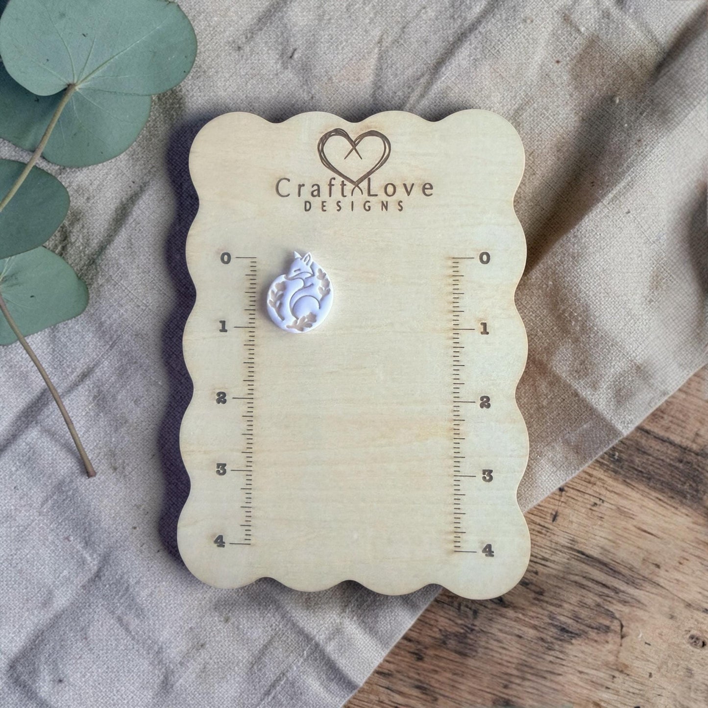 finished fox clay charm shown on Craft Love Designs ruler board