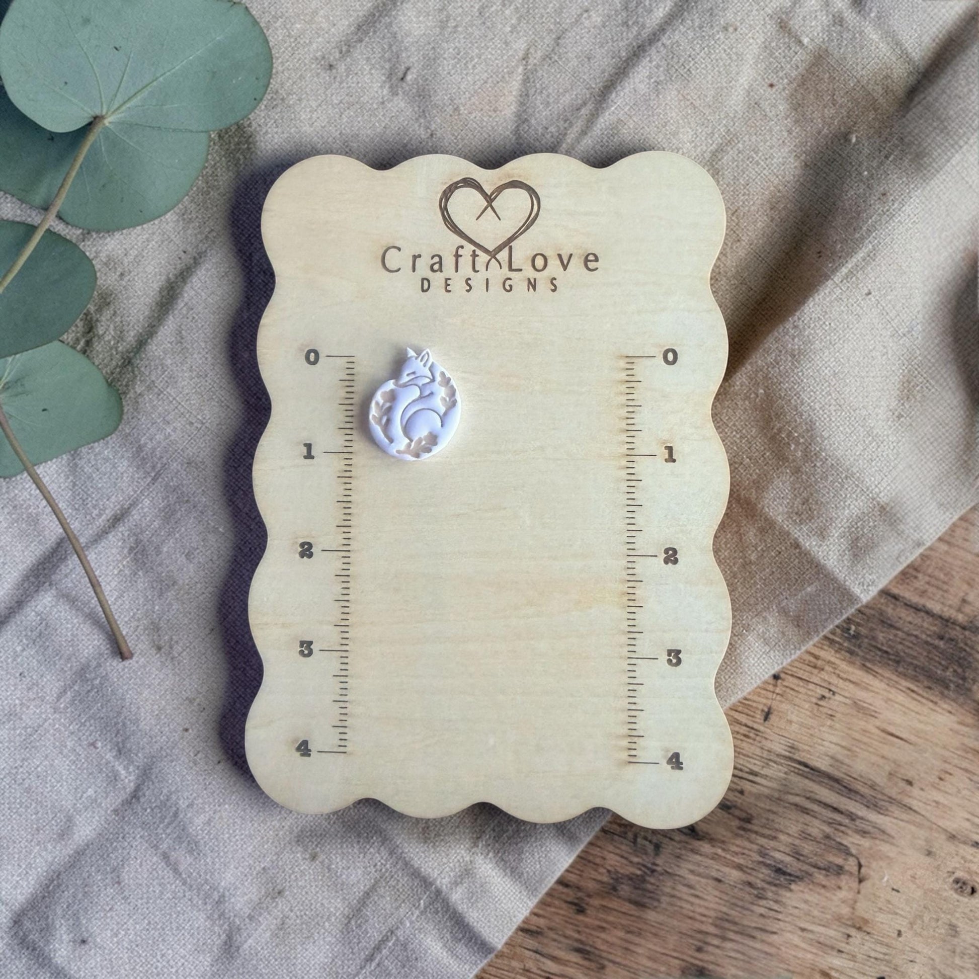 finished fox clay charm shown on Craft Love Designs ruler board