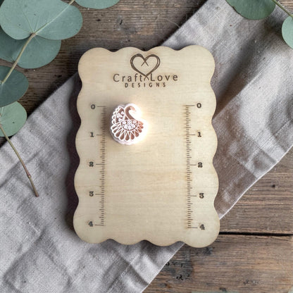 white polymer clay peacock cutter displayed on Craft Love Designs ruler board