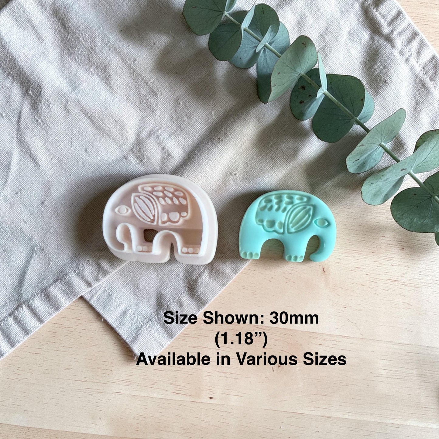 white elephant clay cutter beside finished turquoise elephant charm with size text